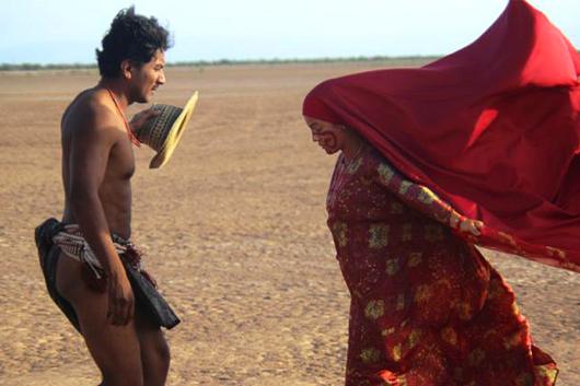 film still from Birds of Passage. Indigenous woman in red confronts man.